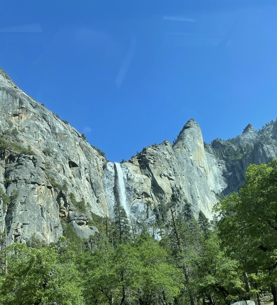 Yosemite waterfall flowing during spring with clear blue sky