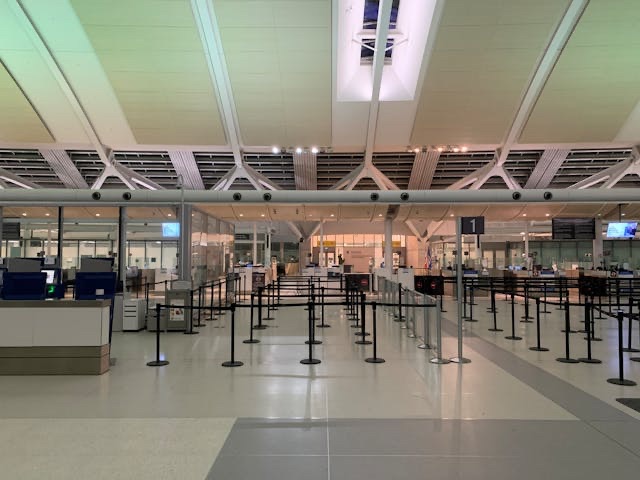 Empty airport security checkpoint with TSA screening lanes and modern terminal architecture